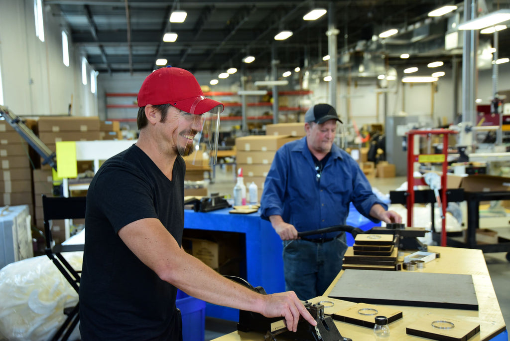 Two men working in a shop both wearing Quickshields.